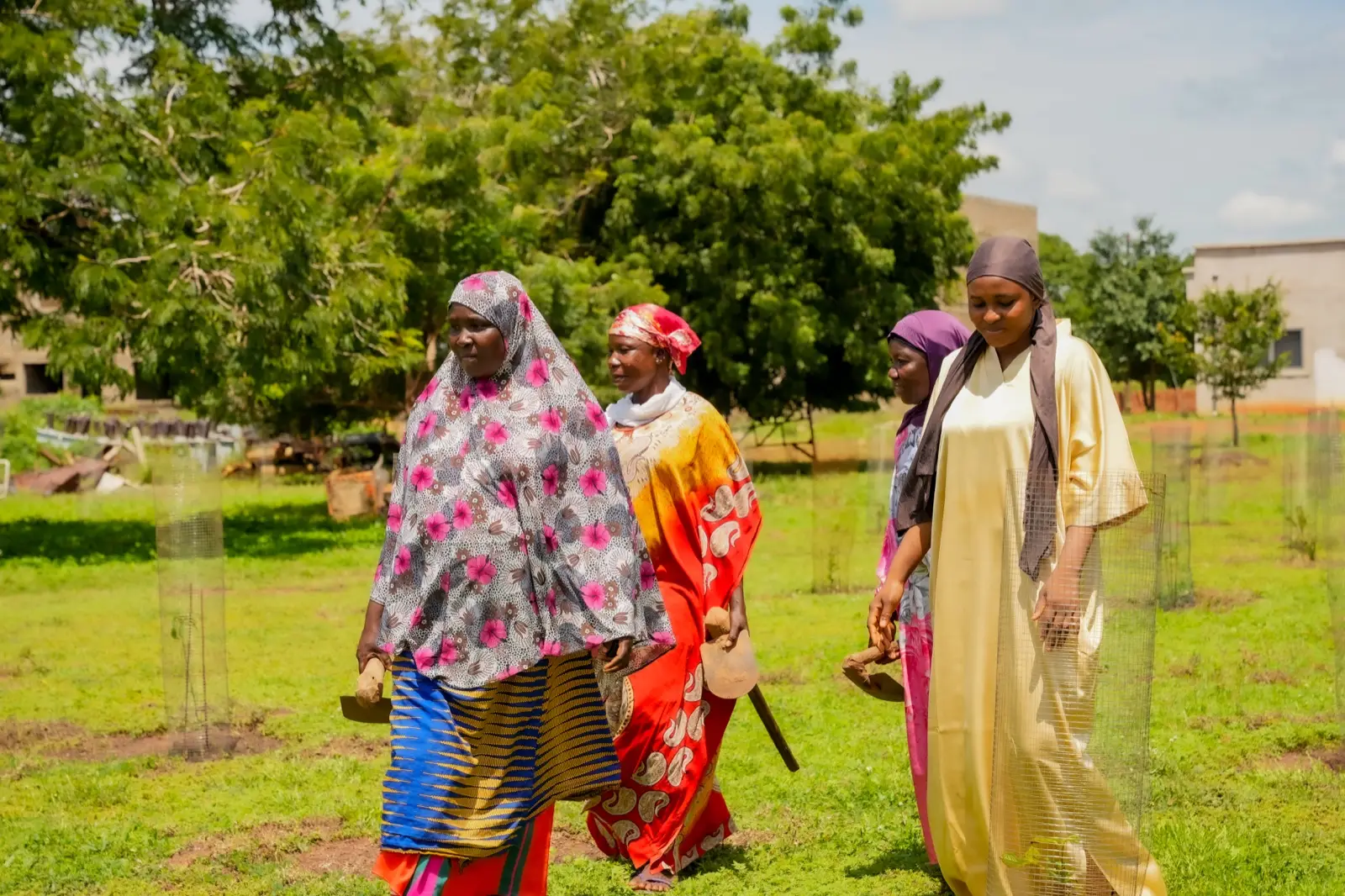 Women walking together through the planted field