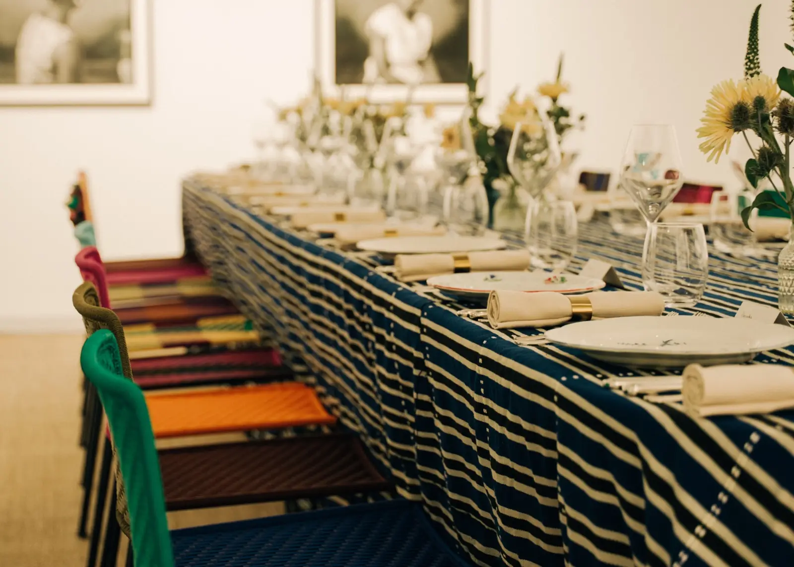 The long table dressed in indigo strip cloth with woven chairs