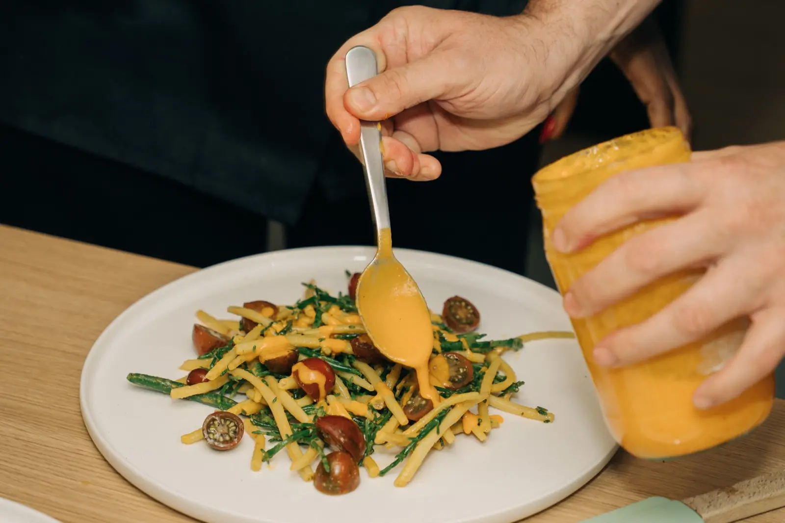 Sauce spooned over a plated dish