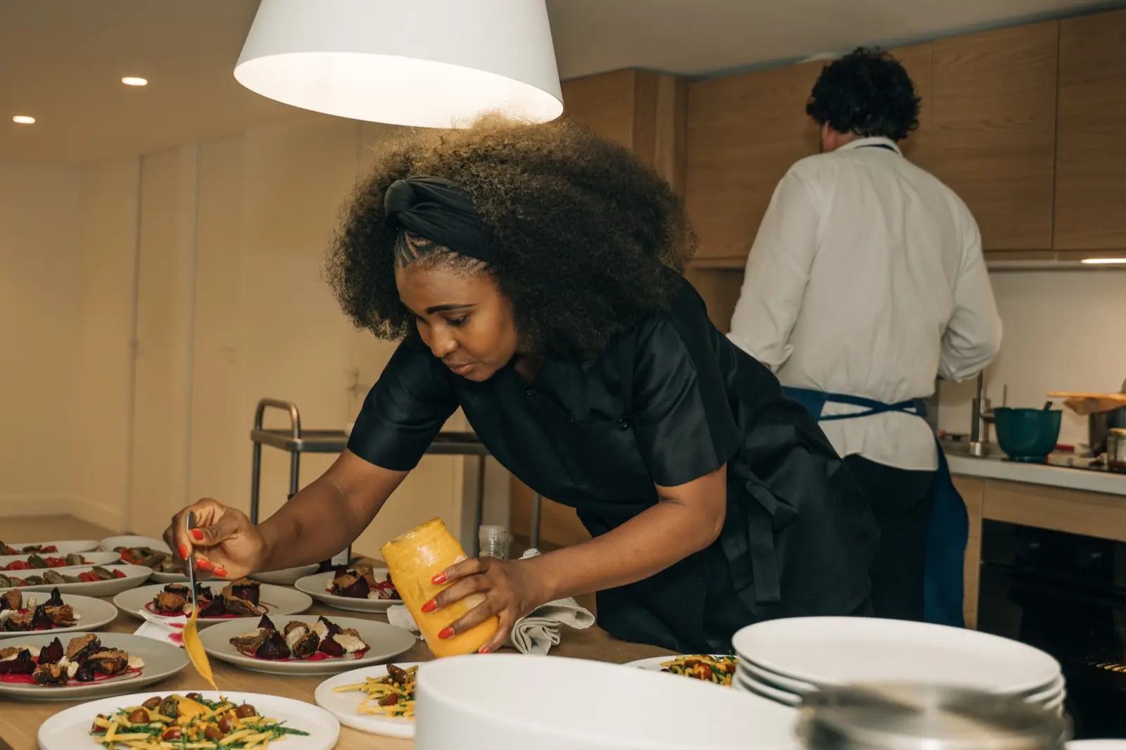 Chef Dee plating in the kitchen