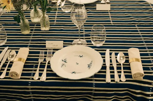 A place setting on indigo strip cloth
